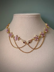 “Elegant Gold Floral Choker with Pink Enamel and Layered Chains”
