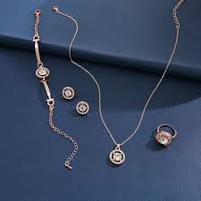A stunning ensemble featuring a necklace, bracelet, ring, and earrings adorned with sparkling stones – perfect for special occasions or gifting.